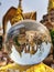 Close-up on a crystal ball with the inverted reflection of a Buddhist temple