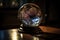 close-up of crystal ball, with light and shadows playing across the glass surface