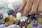 Close up of Crystal healer choosing a tumbled healing stone