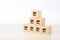 Close-up cube wooden toy block stack in pyramid with franchises store icon for small business standard and best quality