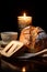 Close-up of cup of coffee, bread loaf and a candle light