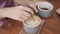 Close up, cup of coffee, female hand puts brown sugar in beverage