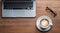 close-up of cup of coffee and laptop keyboard, business mans table, keyboard on the table, close-up of laptop keyboard