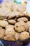 Close up of a cup full of homemade oats and nuts butter cookies.