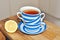 close up of cup of tea with blue stripes at home ,teatime and relax