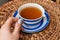 close up of cup of tea with blue stripes at home ,teatime and relax