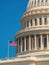 Close up of the cupola of the Capitol in Washington DC with waving US flag