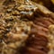 Close-up of a cut roasted steak with crushed pepper, food