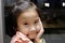 Close up of Cute Asian child girl is smiling happily in the restaurant.