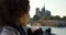 Close up of cute black female sipping coffee and looking around near Notre Dame