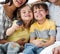 Close-up of cute children watching TV with parents