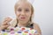 Close-up of cute girl eating birthday cake against gray background