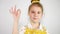 Close up cute girl showing delicious sign. Modern yellow chef uniform. Slow motion