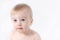 Close-up of cute little adorable funny caucasian topless baby girl or boy on white, light grey background.Healthy skin