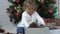 Close up of cute little girl opening Christmas present.