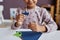 Close-up of cute little learner of nursery school holding tiny paper ship