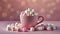 Close-up of cute pink cup filled with marshmallows. Sweet and tasty drink. Pink backdrop