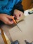 Close up of cutting the braille typed on a piece of paper