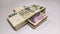 Close-up on Czech 2000 and 1000 banknotes stacked in a stack in a cross on a white background