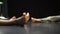 A close up of a dancers foots on floor in slow motion on blurred background