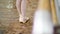 close up, in dancing hall, ballerina in ballet shoes performs tendu aside, grand battement, elegantly, standing near