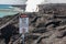 Close up of Danger no tresspassing sign that marks safe viewing spot for bright red lava flow of volcano in Hawai