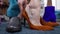 Close-up dark amber shoes and male foot with Fashion tattoo putting on high-heels. Unrecognizable Caucasian gay man