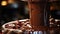 A close-up of a dark chocolate fondue fountain with a cascade of velvety chocolate