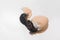 Close-up of dark newborn cute little chick trying to get out of hatching chicken egg shell on white background