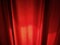 Close-up of dark red curtains in a room. Fabric - red dense velvet