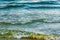 Close-up of dark storm waves sweeping onto beach in winter