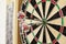 Close Up Of Dartboard With Three Darts In Bullseye