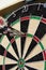 Close Up Of Dartboard With Three Darts In Treble Twenty