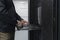 Close up on Data Center Engineer hands Using keyboard on a supercomputer Server Room Specialist Facility with Male