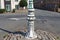Close up of a decorated lamp post stands on a small traffic island on the edge of the town of Colyton in Devon