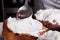 Close-up of decorating home-baked Easter cakes with white icing - a mixture of beaten eggs and sugar with a metal spoon