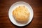 Close-up of deep fried bhature maida puri made from  all purpose flour, served hot in white ceramic plate.