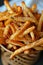 Close up of deep fried crispy french fries cooking in a fryer, delicious golden fries being prepared