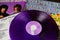 Close up of Deep Purple band album covers with retro purple colored vinyl record