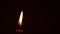 Close-up of defocused candle flame Isolated on the Black Background,