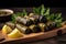 Close-up of delectable stuffed grape leaves with appetizing filling served on a rustic wooden platter garnished with lemon wedges