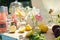 Close-up of a delicate bouquet of flowers in a vase and lemons cut in half against a summer picnic, selective focus