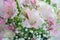 Close-up of delicate flowers of pink lilies, white roses, gypsophila. Floral background. Copy space