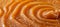 Close up of delicate liquid caramel swirl with smooth lines background texture