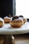 Close up of delicious chocolate topped donut on a vintage cake s