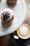 Close up of delicious chocolate topped donuts on a marble platte