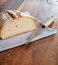 Close up of a delicious, crusty sliced bread on wood old table with knife