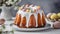 Close-up of delicious Easter bundt cake with white glazing on white table. Tasty holiday dessert