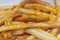 Close-up of delicious french fries with cheese sauce on white ba