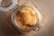 Close-up of delicious freshly baked simple cookies or biscuits  in glass airtight containers